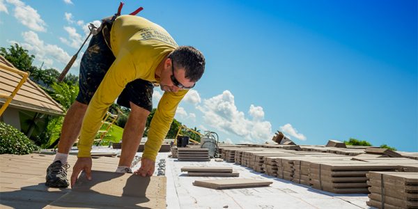 man on roof completing tile roofing services | Gulf Coast Roofing | Naples, Florida