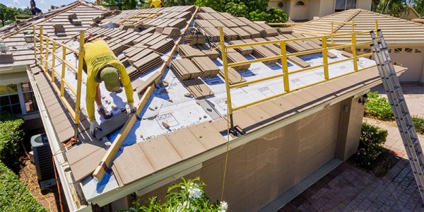 man on roof completing tile roofing services | Gulf Coast Roofing | Naples, Florida