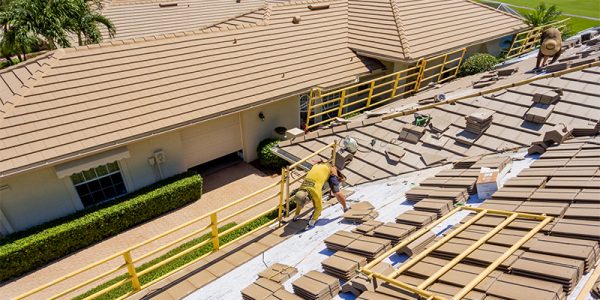 man on roof completing tile roofing services | Gulf Coast Roofing | Naples, Florida